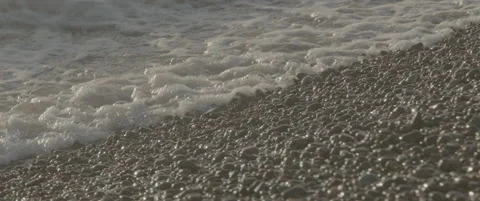 Slow Motion Static Close-Up of Waves Crashing on Shingle Beach Stock-Footage 320114830