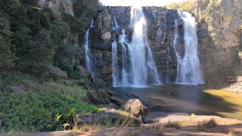 Slow Motion Static Shot Of A Waterfall Framed By Lush Green Forest Stock Footage 340470295