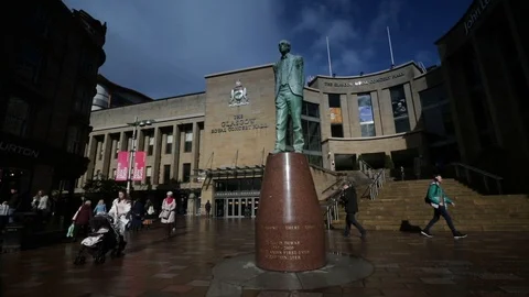 Slow motion of statue of Donald Dewar in front of Glasgow Royal Concert Hall Stock Footage 98973733