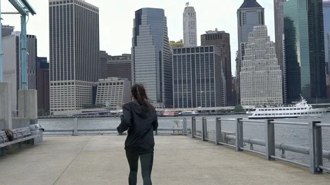 Slow-motion steady cam shot of young fit woman jogging running exercise Stock Footage 99718489