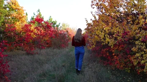 Slow motion steady view on young man coming to blond woman from behind covering Stock Footage 99403132