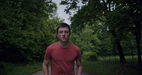 Slow motion, steadycam shot, half close-up of boy running in the countryside. Stock Footage 131868243