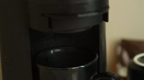 Slow motion steam coming out of hotel coffee maker Stock Footage 22696426