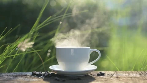 Slow motion of  steaming cup of coffee sits on a wooden surface Stock Footage 295086812