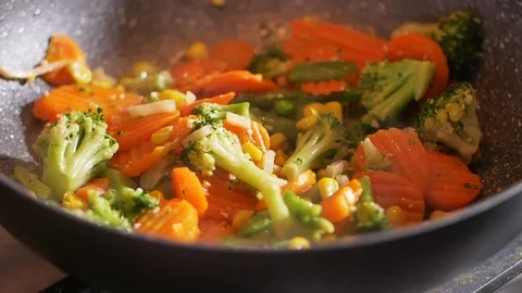 Slow motion of steaming vegetables on frying pan. Healthy lifestyle, vegetarian Stock Footage 107382169