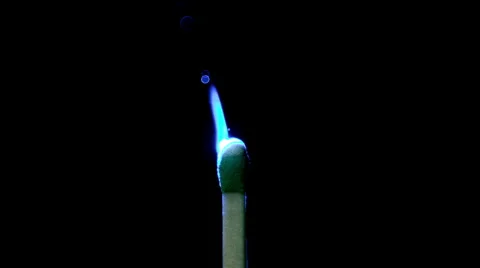 Slow motion of stick match lighting from blue laser pointer. Stock Footage 62342348