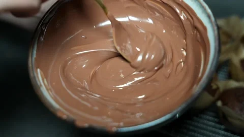 Slow Motion Stirring Melted Milk Chocolate in Bowl Video stock 320393617