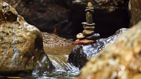 Slow motion stone balance stacking at riverside and morning sunlight. Stock Footage 105988173