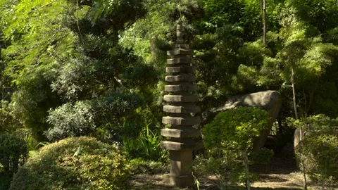 Slow Motion Stone Pillar in Lush Garden with Sunlight Vídeos de archivo 327567185