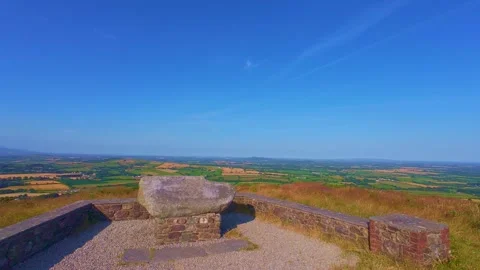Slow motion stone viewpoint bench on top of hill looking over valley Stock Footage 340441618