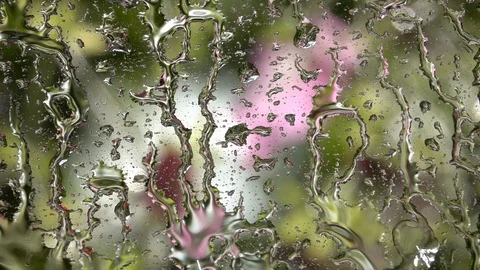 Slow motion of storm dripping on window glass with colorful defocused view Stock Footage 99145303