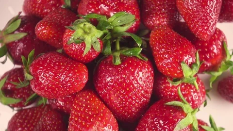 Slow motion strawberry on a white plate turns to the right Stock Footage 90256281