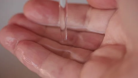 Slow motion: Stream of fresh drinking water pouring into human hands. Stock Footage 168482977