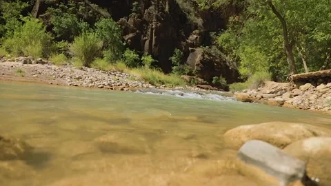 Slow motion stream low to the water in canyon Stock Footage 139930764