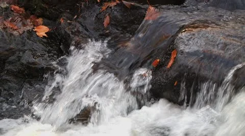 Slow motion stream runs over rocks in fall Stock Footage 8984509