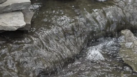 Slow Motion Stream Trickling By Stacks of Forest Rocks Vídeo Stock 229744051