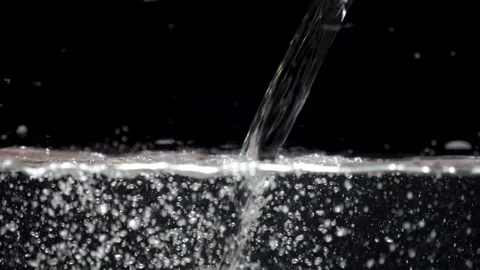 Slow motion stream of water drops down in aquarium on a black background Video stock 195018055