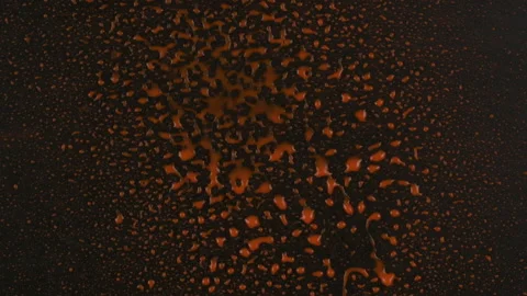 Slow motion. Streams of red paint fall into the center of a black background and 库存影片 168570765
