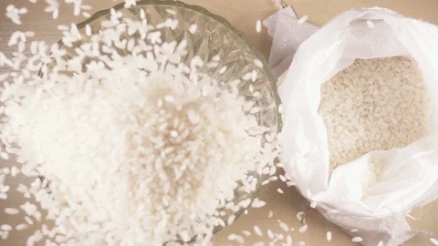 Slow motion strew white long grain rice in a bowl Stock Footage 92088432