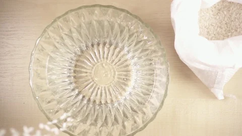 Slow motion strew white long grain rice in a bowl Stock Footage 92088579