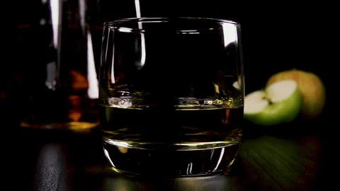 Slow motion in a strong alcoholic drink in a glass pour the juice Stock Footage 92541871