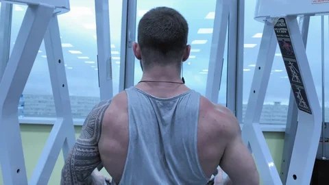 Slow motion. Strong caucasian training in a fashionable modern gym. Male body Stock-Footage 117938433
