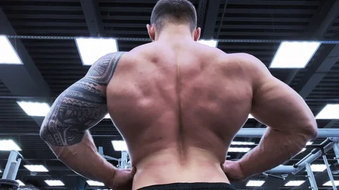 Slow motion. Strong man bodybuilder. Male bodybuilder. Young brutal male body Stock-Footage 117938575