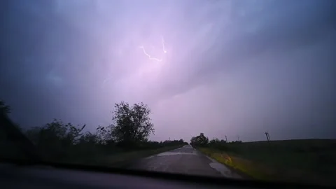 Slow motion of a strong thunderstorm with lightning through a car window. Stock Footage 219729807