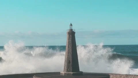 Slow motion strong waves crash against a lonely lighthouse in the open ocean Stock-Footage 146538540