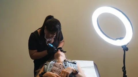 Slow motion studio shot of microblading in progress with ring light and full Stock Footage 307479728