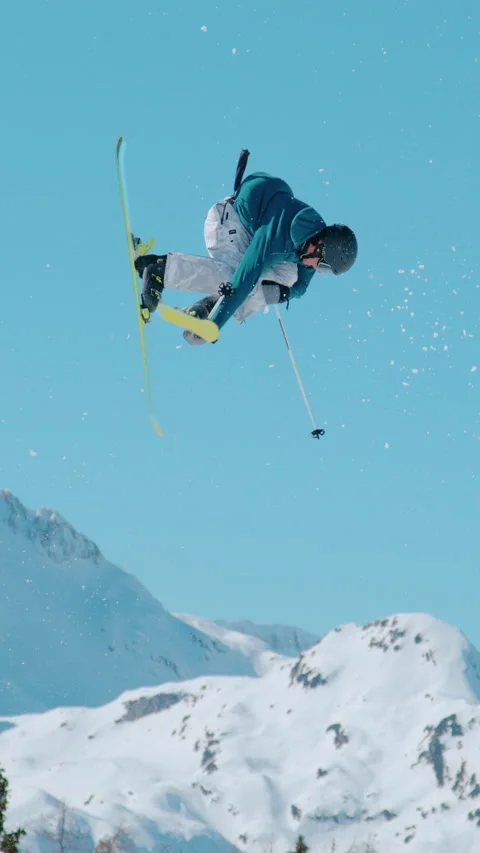 SLOW MOTION: Stunning view of freestyle skier doing trick while jumping kicker Stock Footage 295706612