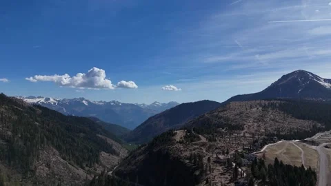 Slow Motion Style Drone Push Revealing Winding Mountain Pass and Alps Horizon Stock Footage 339311010