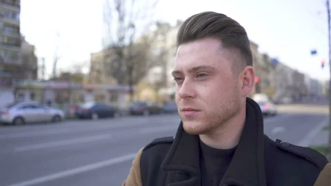 Slow motion. Stylish young attractive man stand on street with cars. Portrait Stock Footage 130637027
