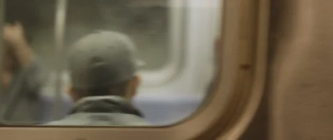 Slow motion of a subway train passing by in the metro station of New York Stock Footage 129842726