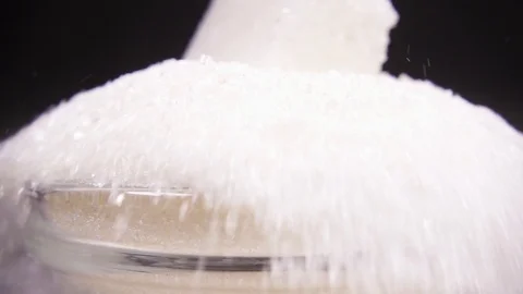 Slow motion sugar cube falls into sugar close up Stock Footage 95783091