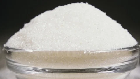 Slow motion sugar cube hits the edge of the bowl with sugar close-up Video stock 95792808