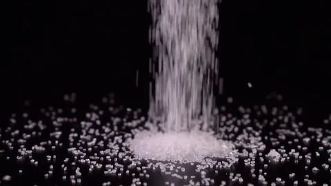 Slow-motion sugar drop close-up on a black background 動画素材 123860603