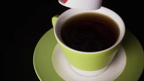 Slow motion. Sugar substitute in tablets falls into tea Stock Footage 74268239