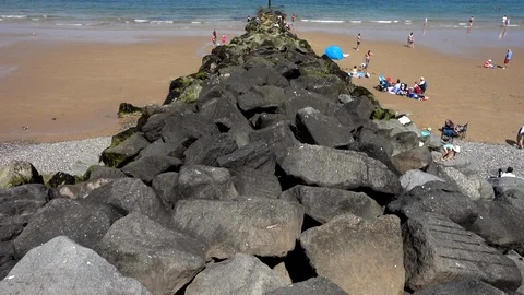 Slow motion: Summer beach scene at Sheringham, Norfolk, England, UK. Stock Footage 93102541