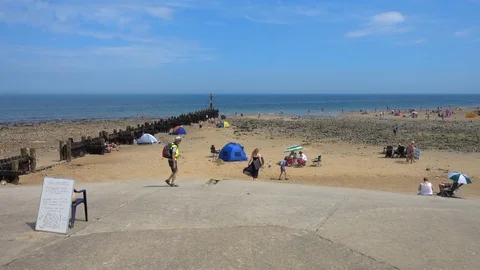 Slow motion: Summer beach scene at West Runton, Norfolk, England, UK. Stock Footage 93120938