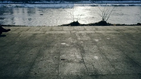Slow motion: Sun casts shadows of people walking on the waterfront. 4k. Видео 103473127