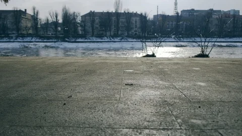 Slow motion: Sun casts shadows of people walking on the waterfront. 4k. Видео 103473671