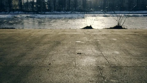 Slow motion: Sun casts shadows of people walking on the waterfront. 4k. Видео 103475336