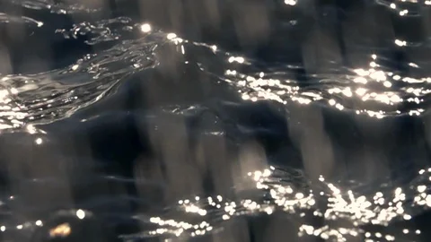 Slow motion of sun falling drops  and powerful ripple close up. Stock Footage 96885261