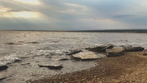 SLOW MOTION. Sun rays emerging through clouds in the middle of the rough exotic  Stock-Footage 117273751