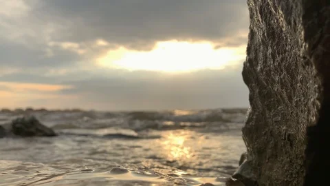 SLOW MOTION. Sun rays emerging through clouds in the middle of the rough exotic  Stock-Footage 117273926