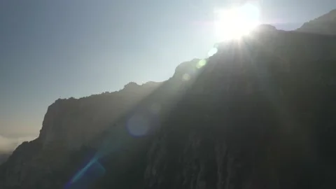 Slow motion of the sunlight streaming over beautiful mountains of Montserrat in Stock Footage 136392055