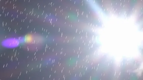 Slow motion of sunny shower with horizontal moving sun and vibrant lens flare. Stock Footage 100239388