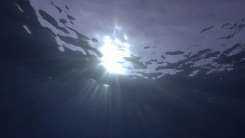 Slow motion, Sunrays penetrate through the surface of the water. Underwater Stock Footage 119214434