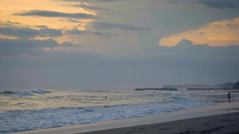 Slow motion of sunset beach with high tide waves and people in ocean Stock Footage 113604010